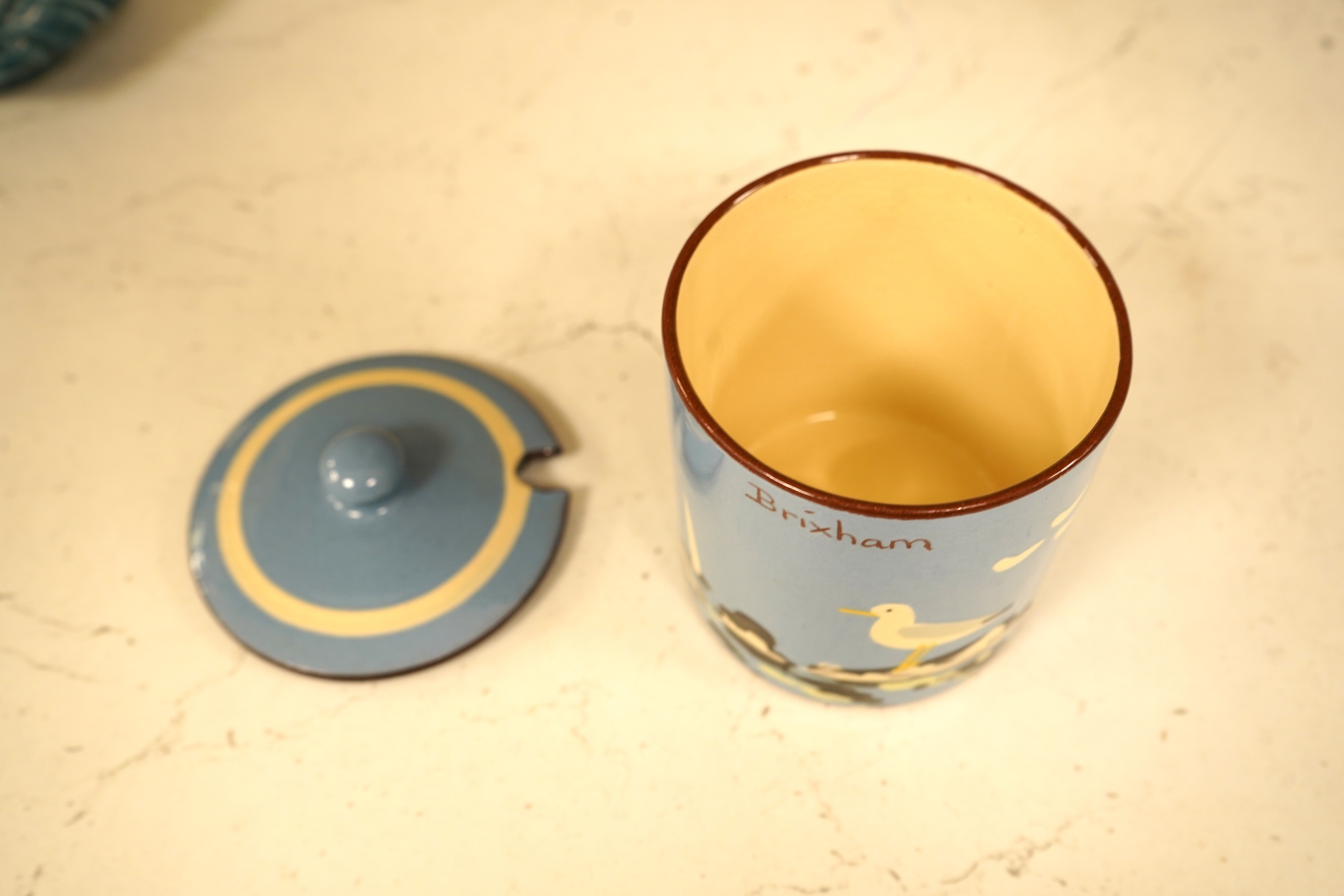 A Poole Pottery hors d’ouevres dish, a dolphin, a box and cover and a Torquay ware Brixham jar